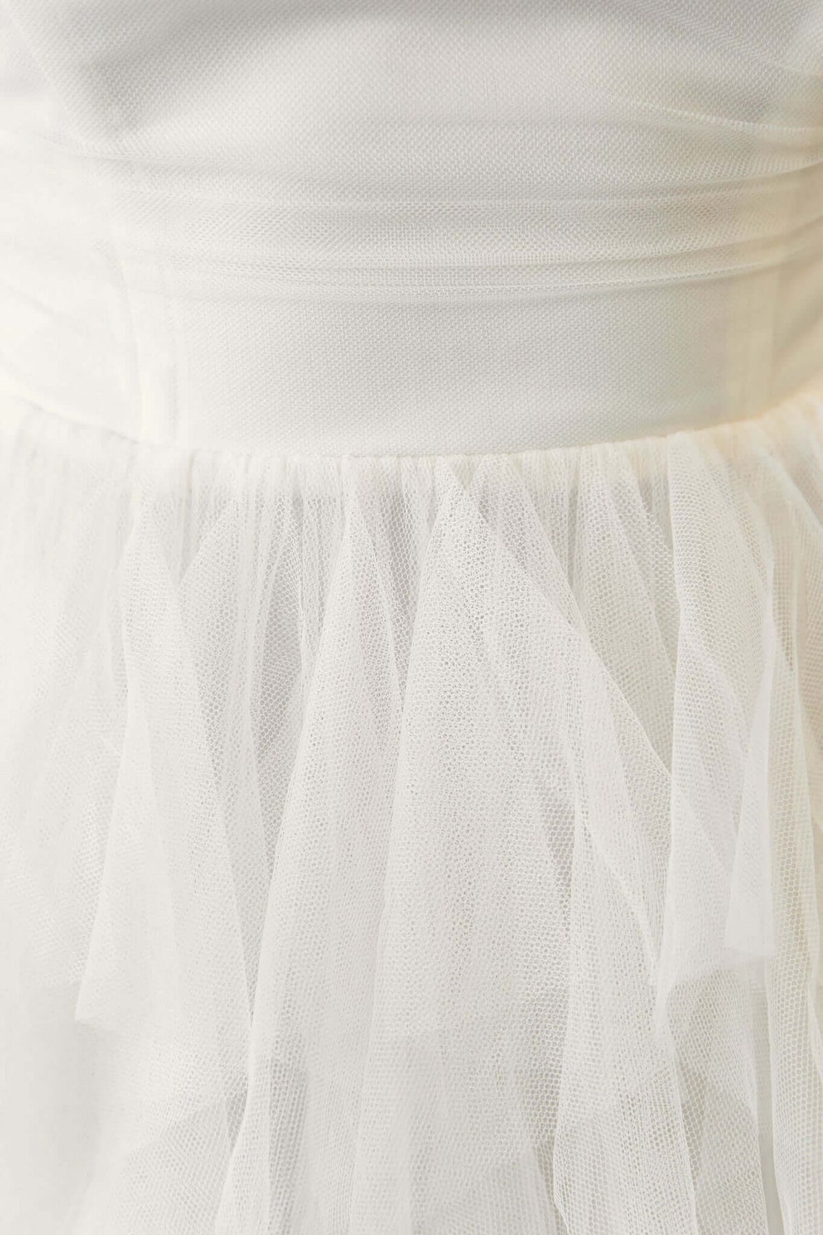 Close-up of the Carrie Maxi Dress showcasing the strapless design and tulle overlay detail.