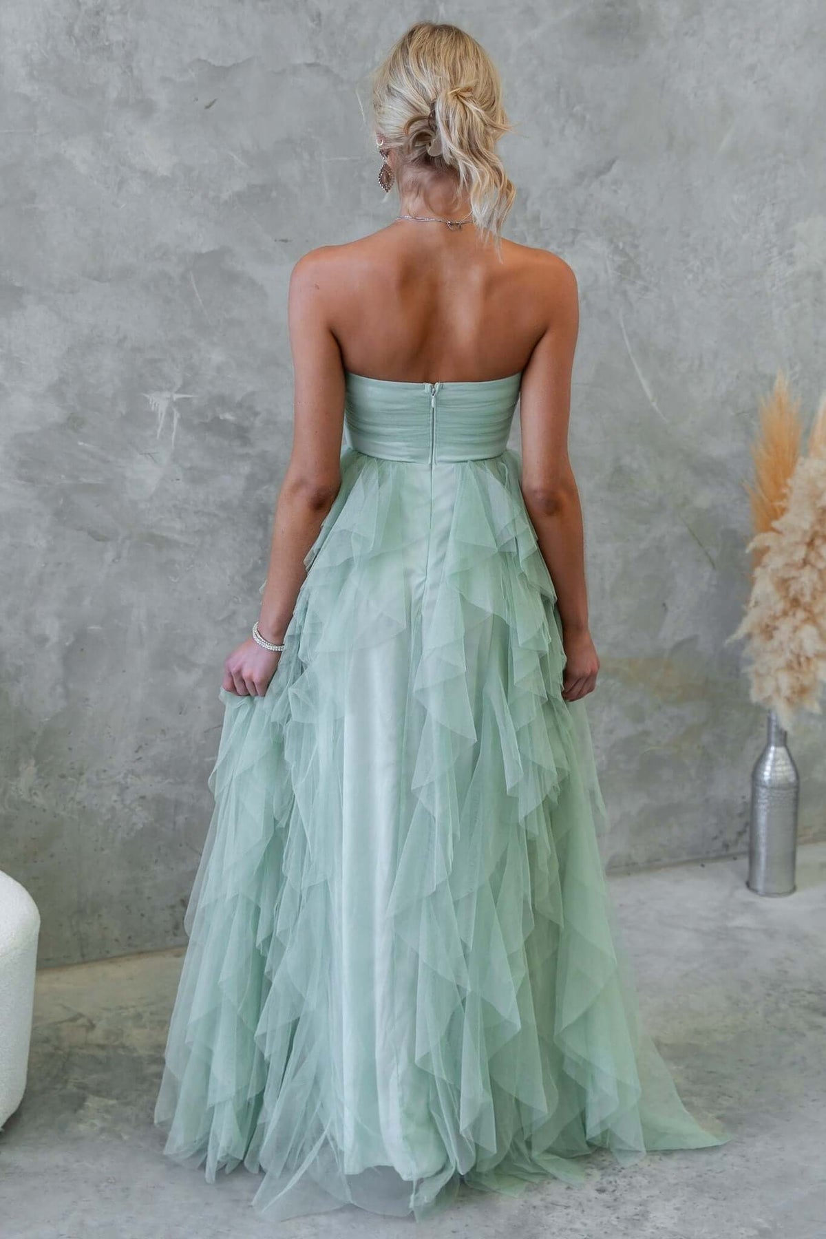 Back view of Carrie Maxi Dress in mint green with layered tulle, strapless design, and invisible zip.