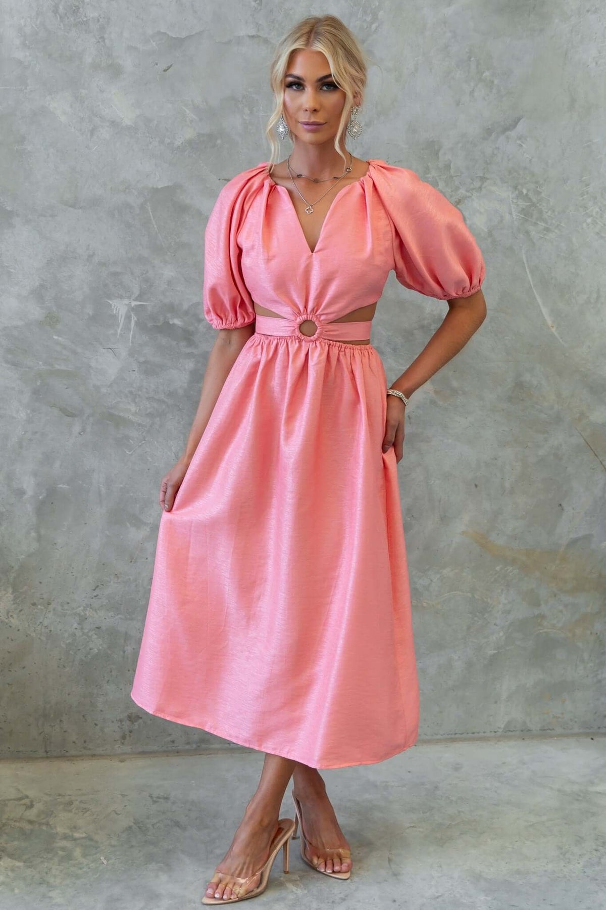 Isabelline midi dress in soft pink with puff sleeves, V-neckline, and cut-out waist detail, perfect for stylish occasions.