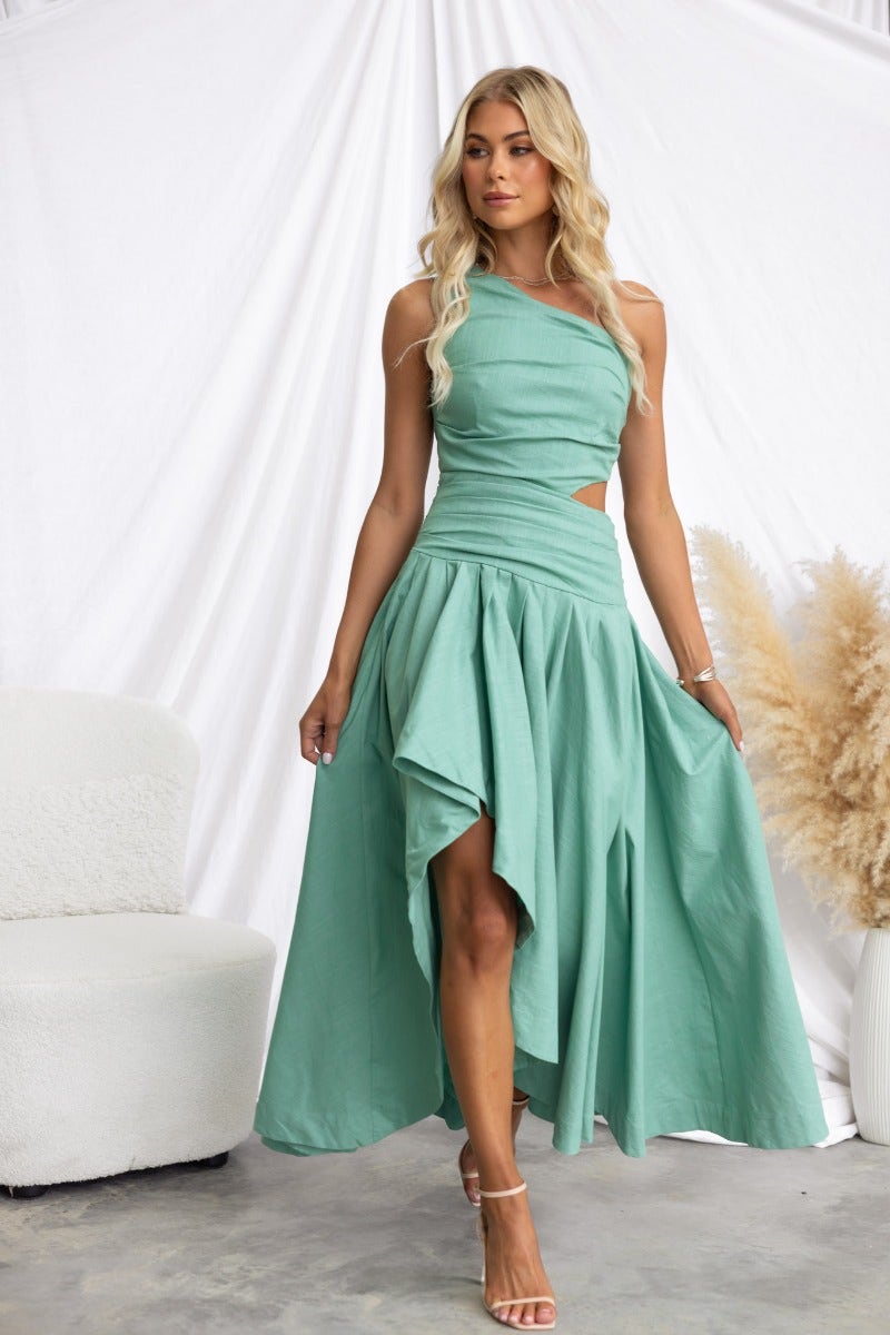 Model wearing a mint green Horizons Maxi Dress with a one-shoulder neckline and cut-out waist.
