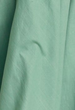 Close-up of soft cotton blend fabric in mint green, showcasing texture and subtle draping of the Horizons Maxi Dress.