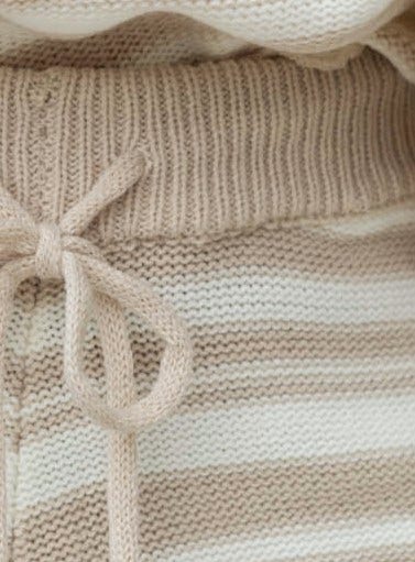 Close-up of the elastic waistband and drawstring detail of the Wilana Set knit shorts in beige and cream stripes.
