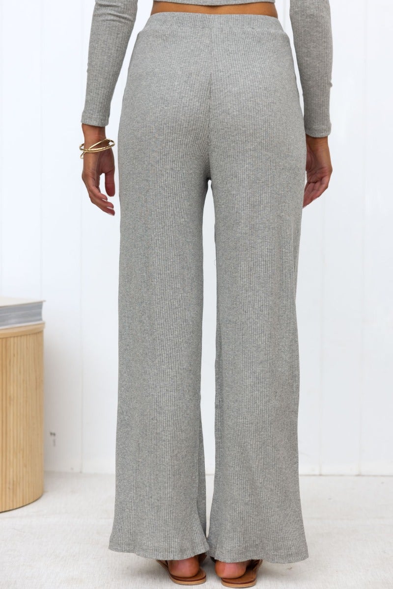 Back view of Smitten ribbed knit pants with wide legs and elastic waistband, styled in grey.