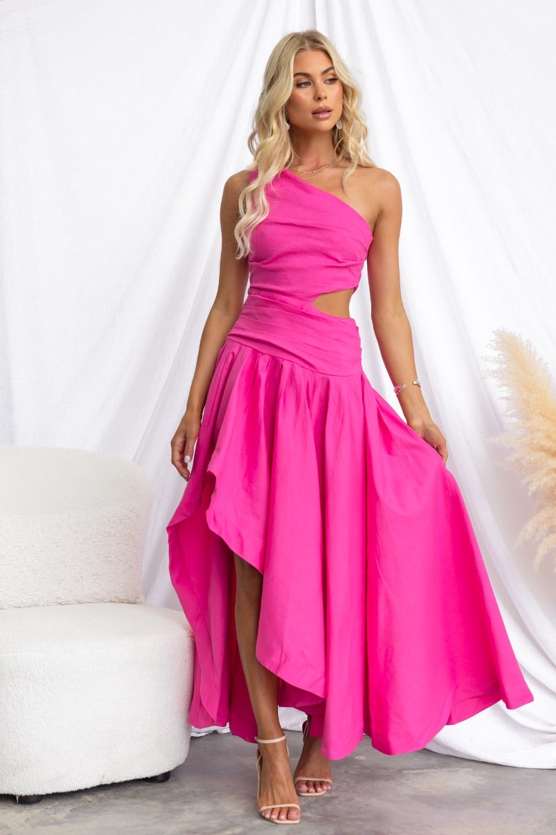 Model wearing a pink cotton blend Horizons Maxi Dress with one-shoulder neckline and cut-out at waist.
