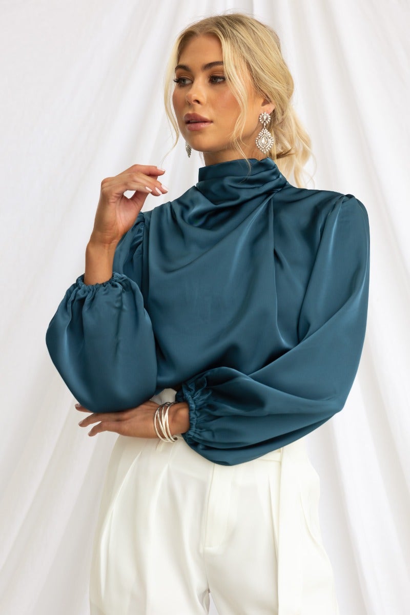 Teal satin high-neck top with elastic cuffs and lined design, perfect for elegant occasions.