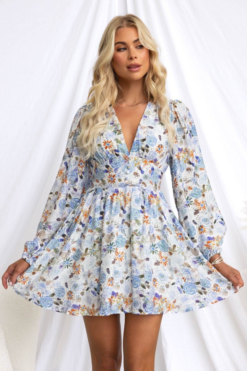 Floral print V-neck dress with puff sleeves and button details, perfect for a casual day out.