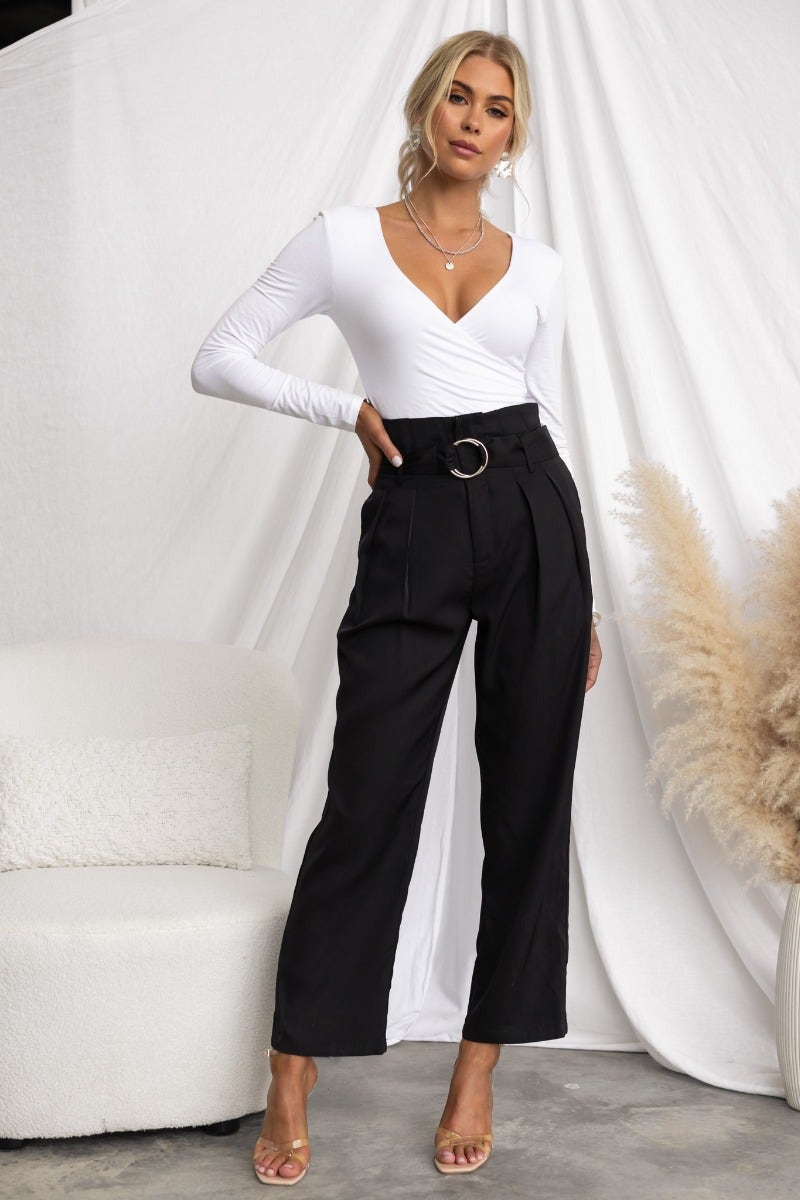 Model wearing Tahni Pants featuring a removable belt and mid-high waist, styled with a white top and minimal accessories.