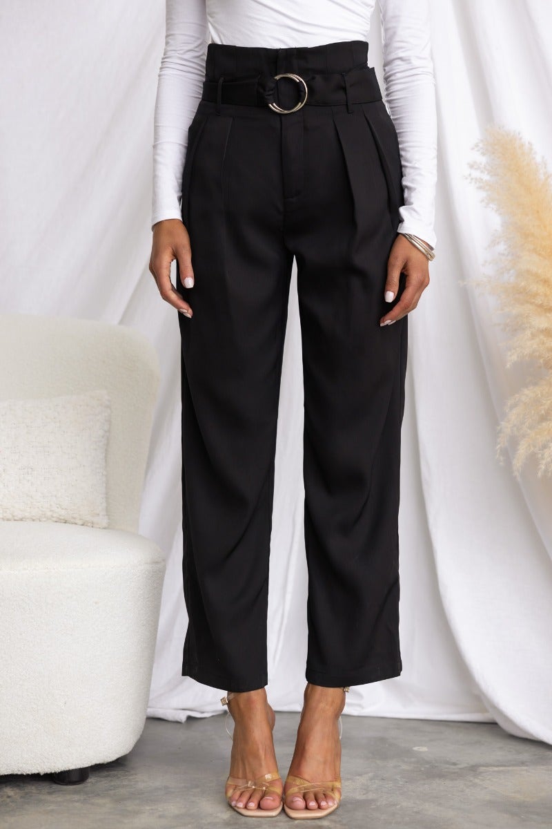 Tahni Pants in black with mid-high waist and removable belt, styled with a fitted top and minimal accessories.