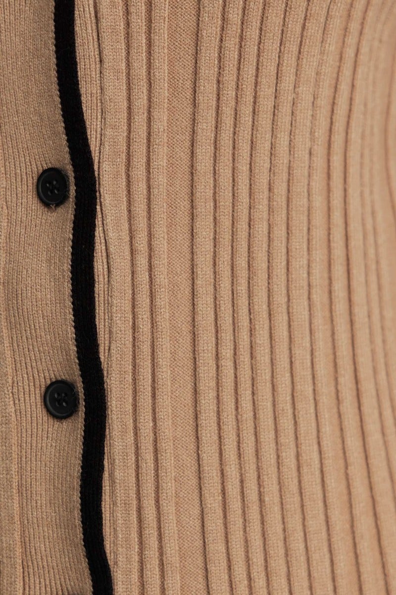 Close-up of Shilah Top featuring ribbed knit fabric, button-up front, and contrasting black trim.