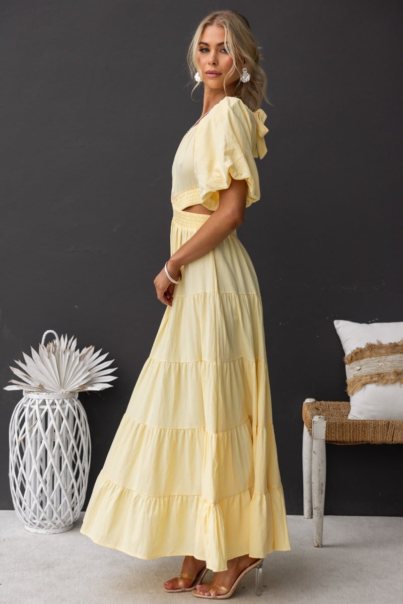 Posh maxi dress in soft yellow cotton, featuring an off-shoulder neckline and cut-out waist detail.