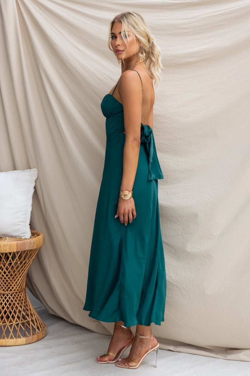 Elegant green Allion midi dress with adjustable straps and tie detail at back, showcased on model.