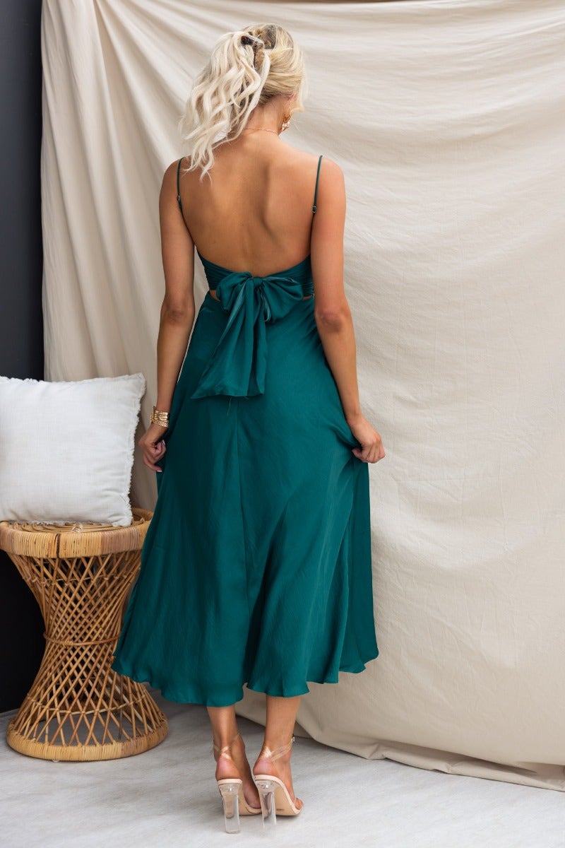 Back view of Allion green midi dress featuring adjustable straps and a tie detail at the back.