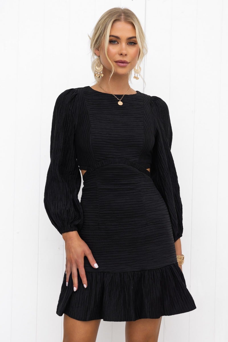 Black textured Tovia dress featuring round neckline, cut-out waist, and puffed sleeves with elastic cuffs.
