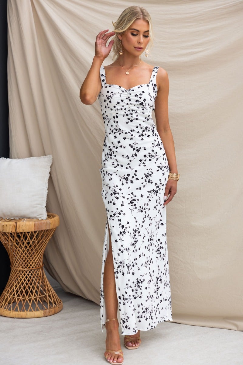 Neila Maxi Dress featuring a floral print, adjustable straps, low-cut back, and front split, perfect for warm days.