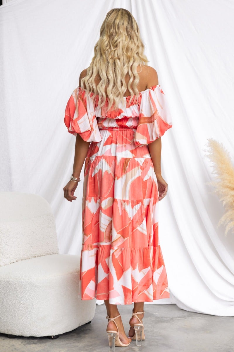 Back view of a multi-colour Quetta midi dress with elastic neckline and flared sleeves.
