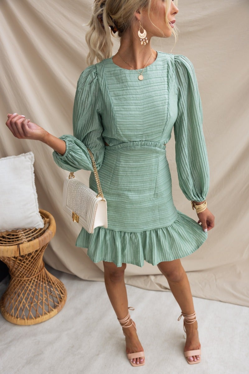 Tovia Dress featuring textured material, round neckline, and cut-out waist in mint green.