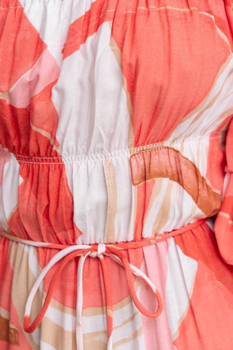 Close-up of Quetta Midi Dress featuring multi-colour print, elastic neckline, and removable fabric tie detail.