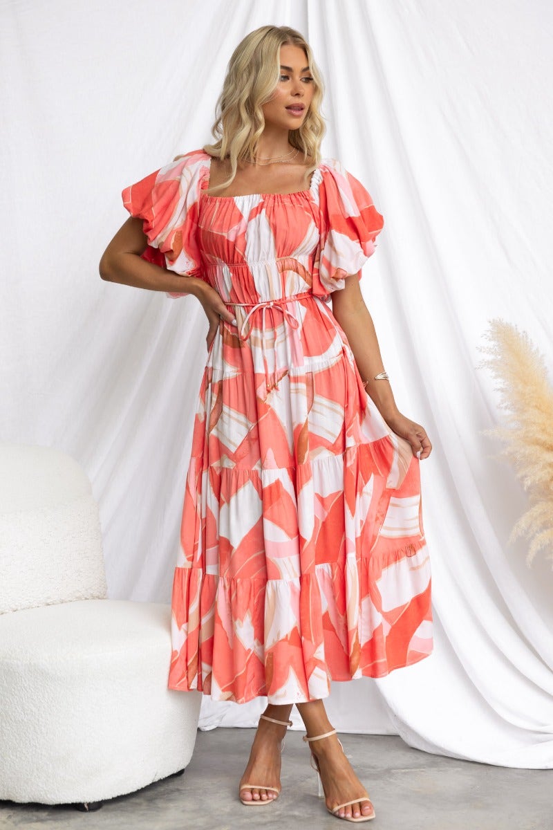 Stylish Quetta midi dress in multi-color print with elastic neckline and removable fabric tie, worn by a model.