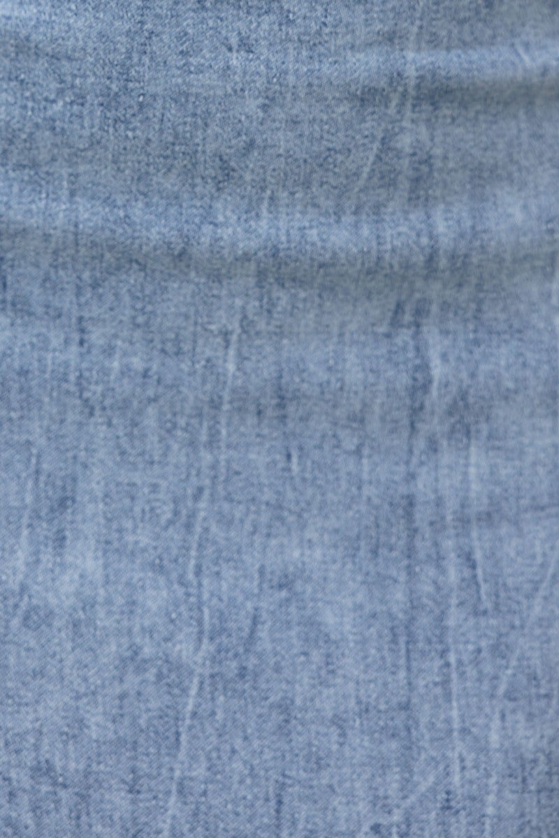 Close-up of soft denim texture showcasing the unique wash details of the Irving Denim Maxi Dress.