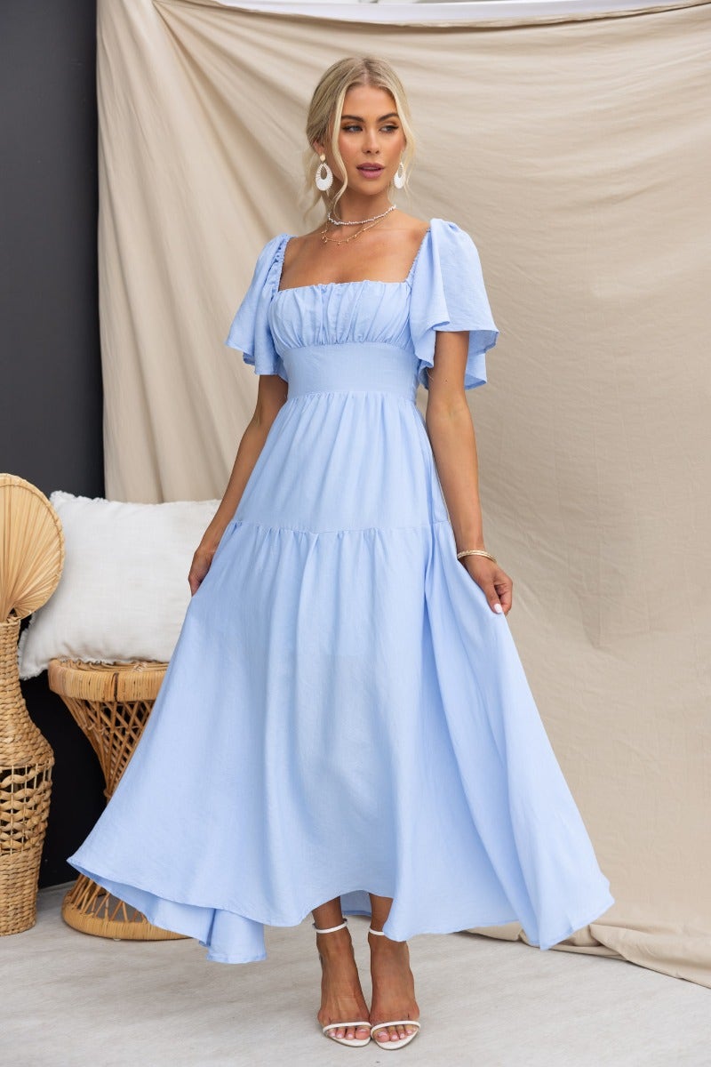 Hanni Maxi Dress in light blue, featuring flutter sleeves and a flattering fit for summer occasions.