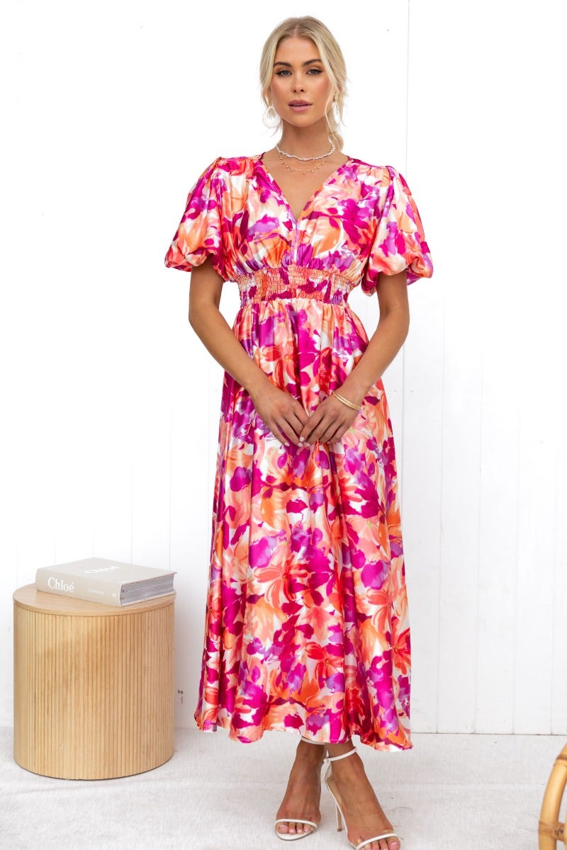 Floral print Blazing Maxi Dress with V-neckline and elastic waist, modeled by a woman in a bright pink color scheme.