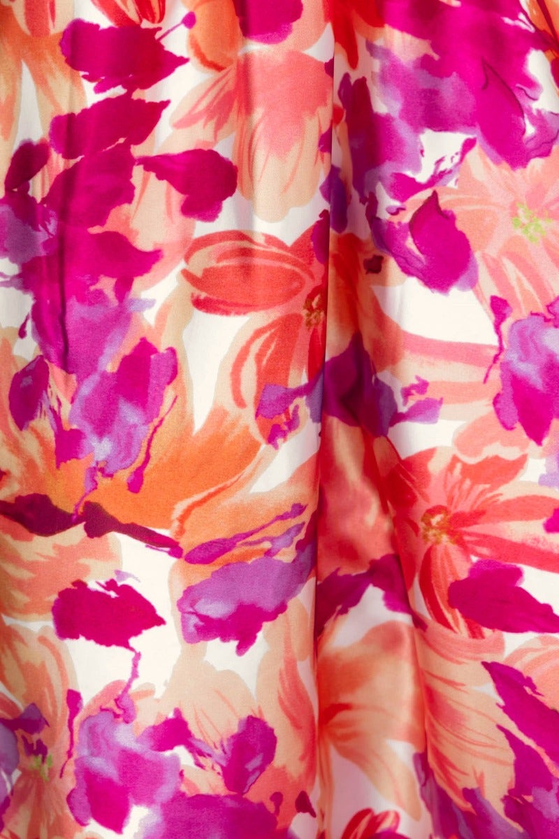 Vibrant floral print in shades of pink and orange on satin fabric, perfect for a stylish maxi dress.