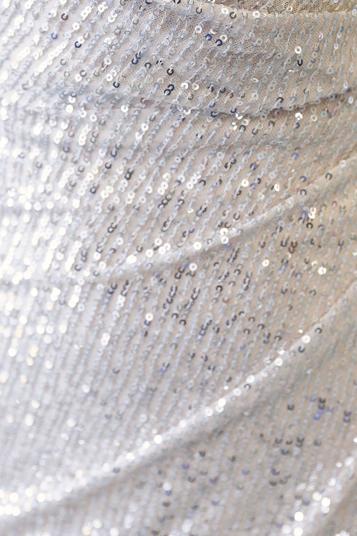 Close-up of shimmering silver sequins on a fabric, showcasing the elegant texture and sparkle.