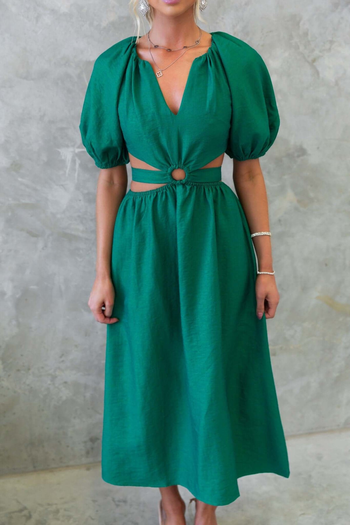 Isabelline Midi Dress in vibrant green with V-neckline, puff sleeves, cut-out waist, and fabric tie detail.