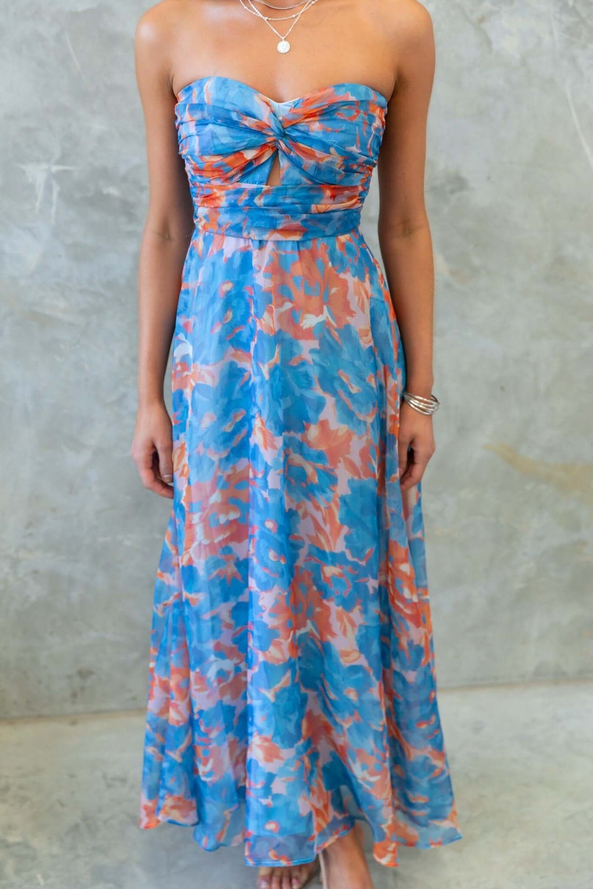 Ivrea Midi Dress featuring a strapless design with a colorful floral pattern and flattering silhouette.