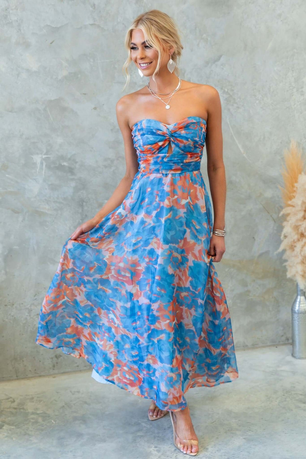 Ivrea Midi Dress: Strapless floral print dress in blue and coral, featuring a fitted bodice and flowy skirt.
