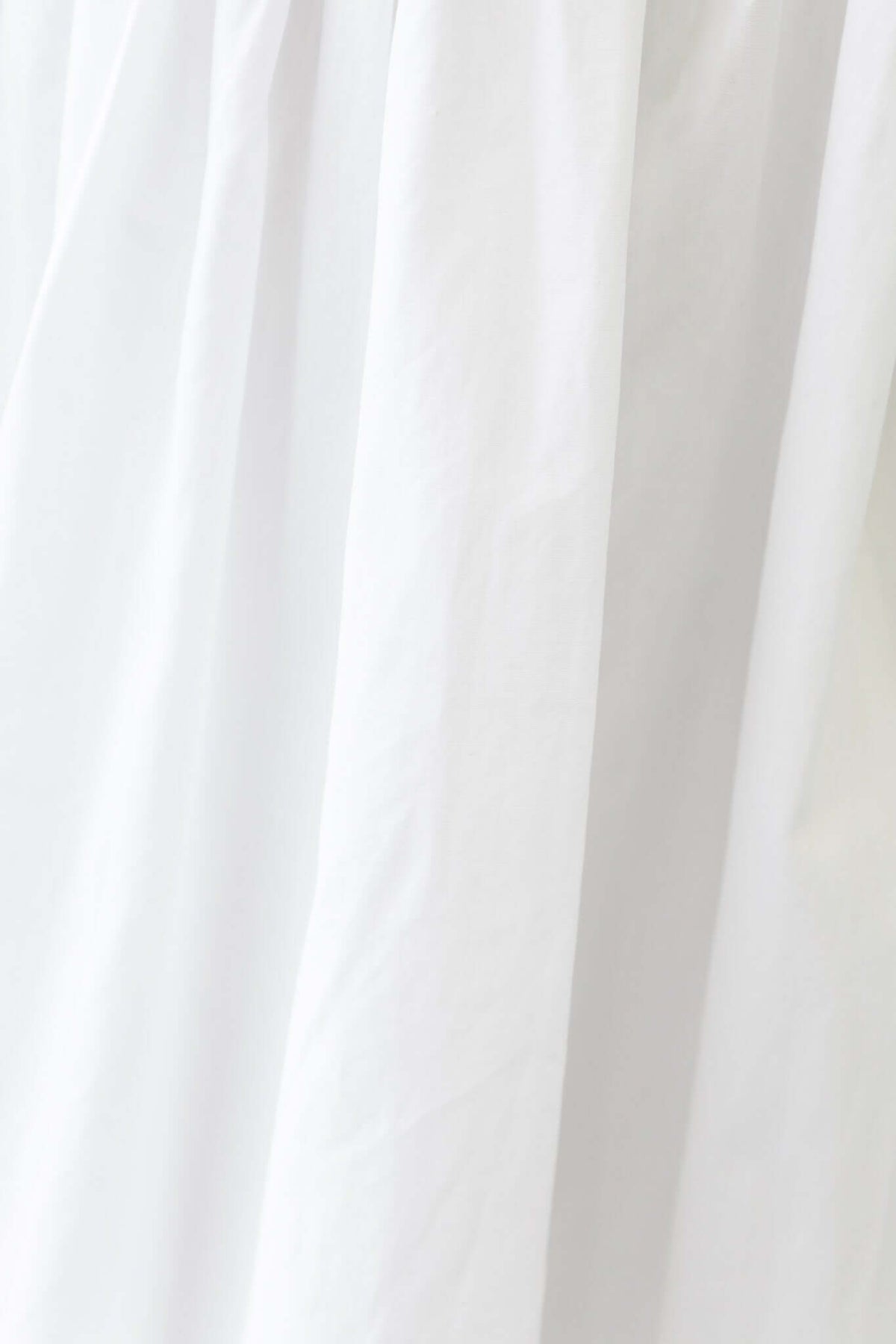 Flowy white fabric of the Cloud Nine Midi Skirt, showcasing its soft cotton material and elegant drape.