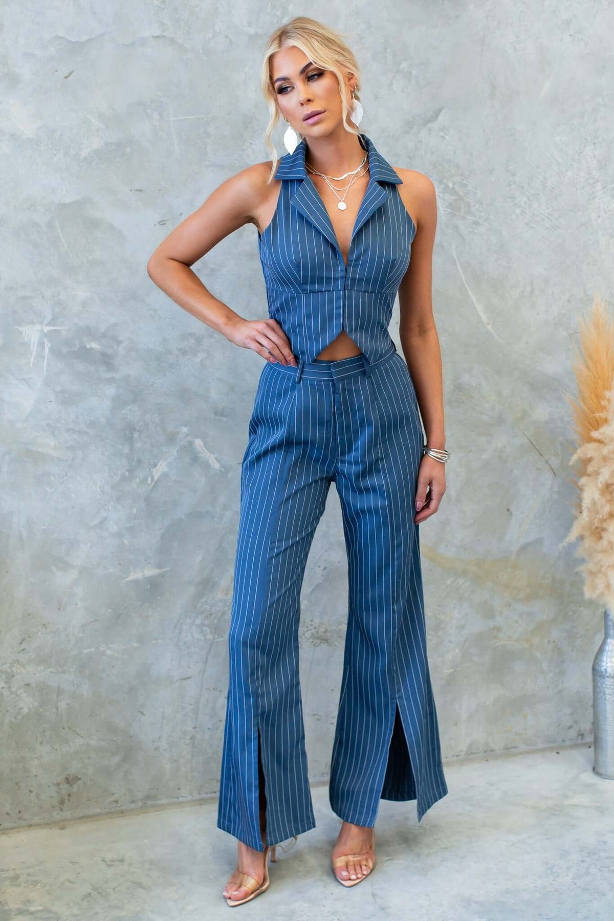 Model wearing the Lanai Top with matching striped pants, showcasing modern fashion and stylish design.