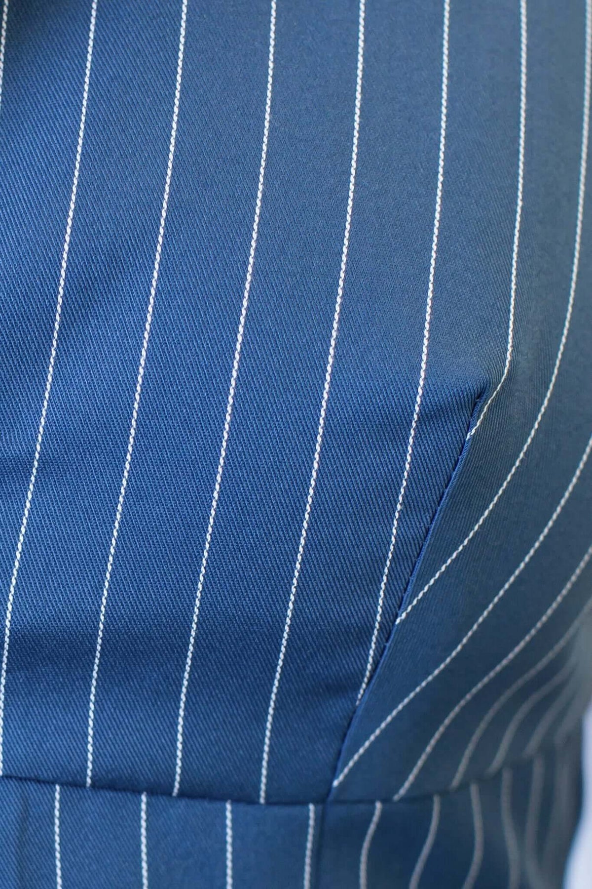 Close-up of the Lanai Top featuring navy fabric with white pinstripes and precise stitching details.