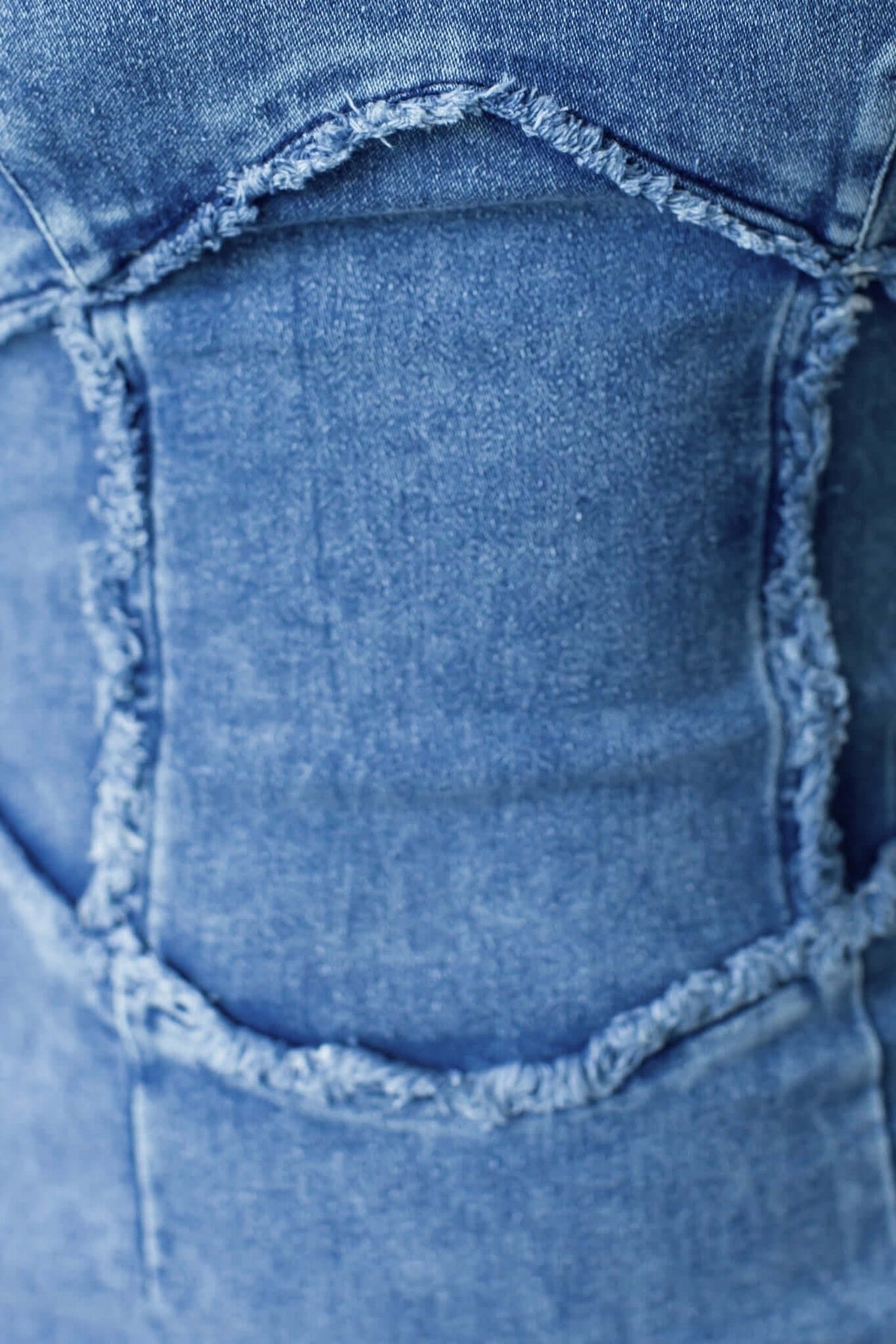 Close-up of the back detail of the Heads Turn Denim Maxi Dress, featuring frayed edges and a unique design.