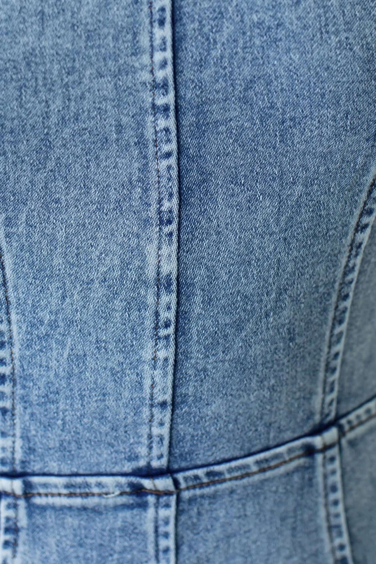 Close-up of the denim fabric on the Duet Denim Maxi Dress showcasing its texture and stitching details.