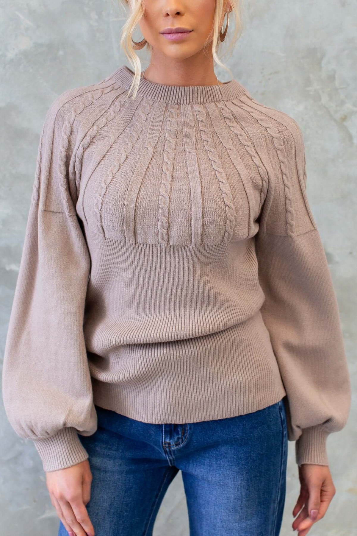 Alma Jumper with round neckline in cable knit style, featuring puff sleeves and a relaxed fit, perfect for stylish comfort.