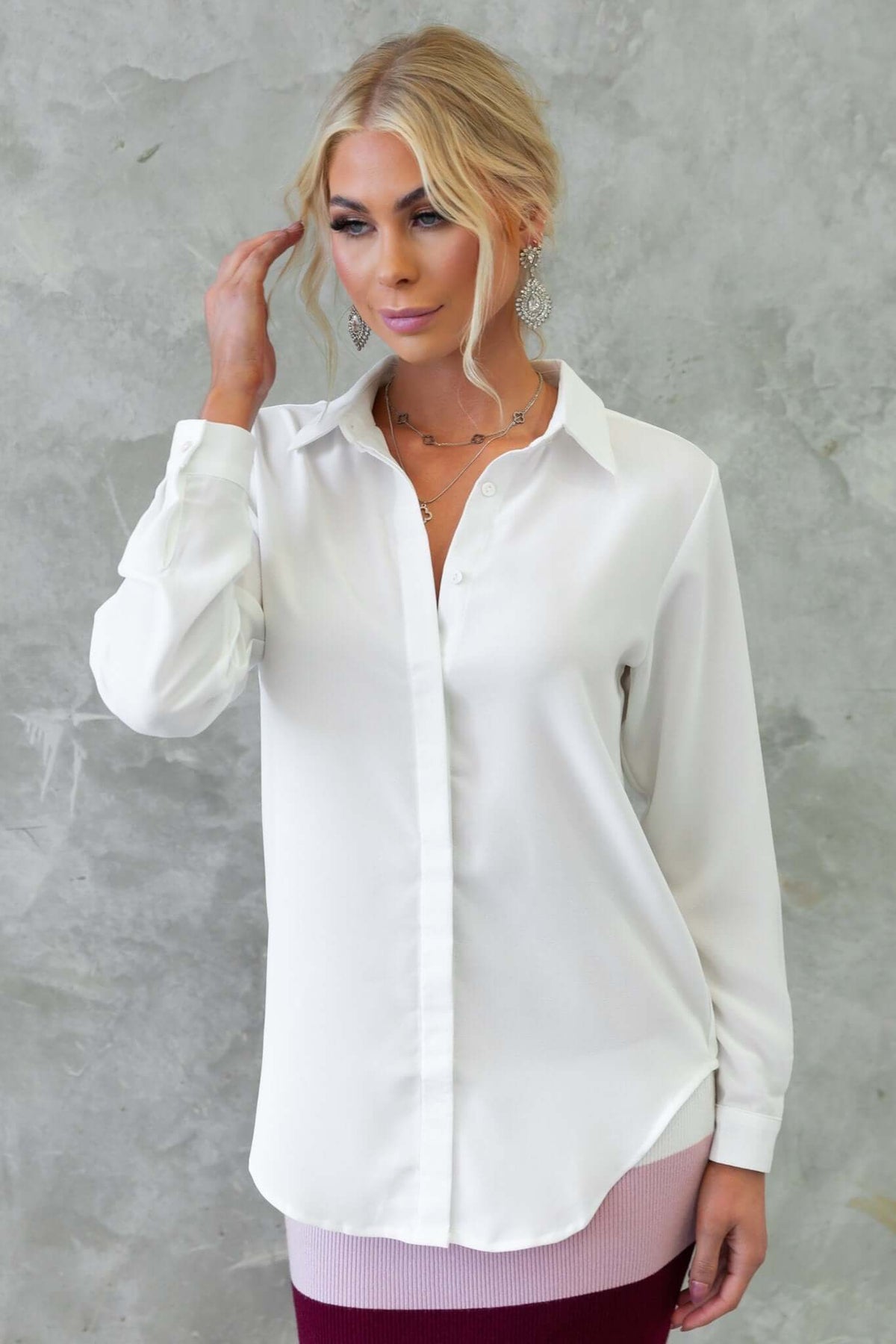Model wearing the Toomba Shirt, a white button-up shirt made of light polyester, perfect for a slightly relaxed fit.