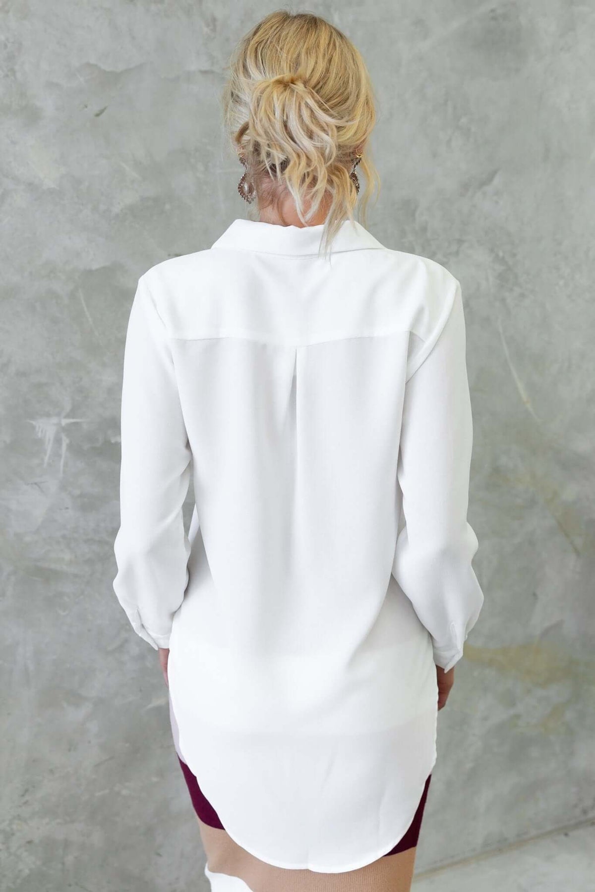 Back view of the Toomba Shirt, a white button-up shirt with a relaxed fit and soft, lightweight polyester fabric.