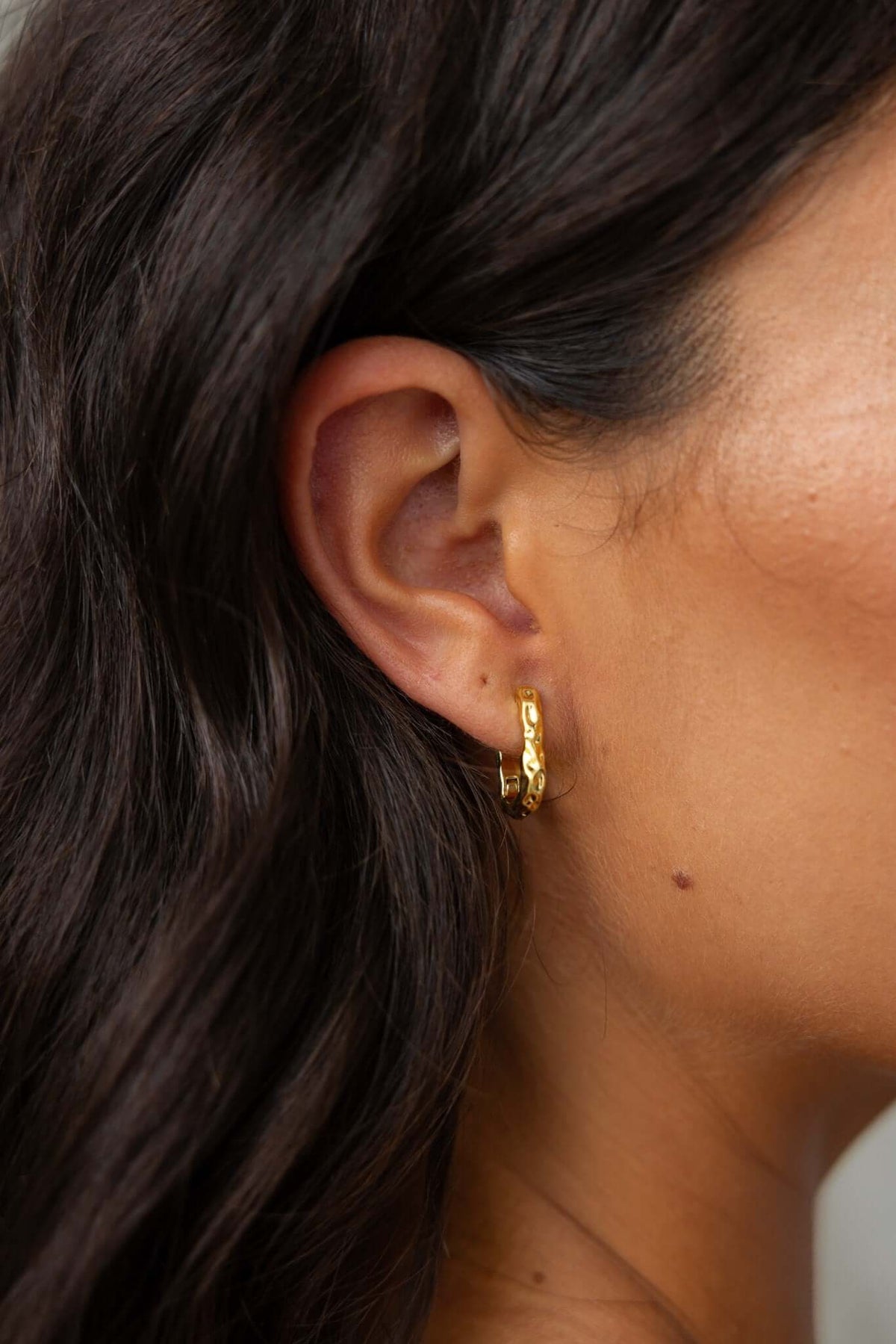 Gold Laila Earrings showcased on model, close-up view highlighting clasp closure and 2cm length.