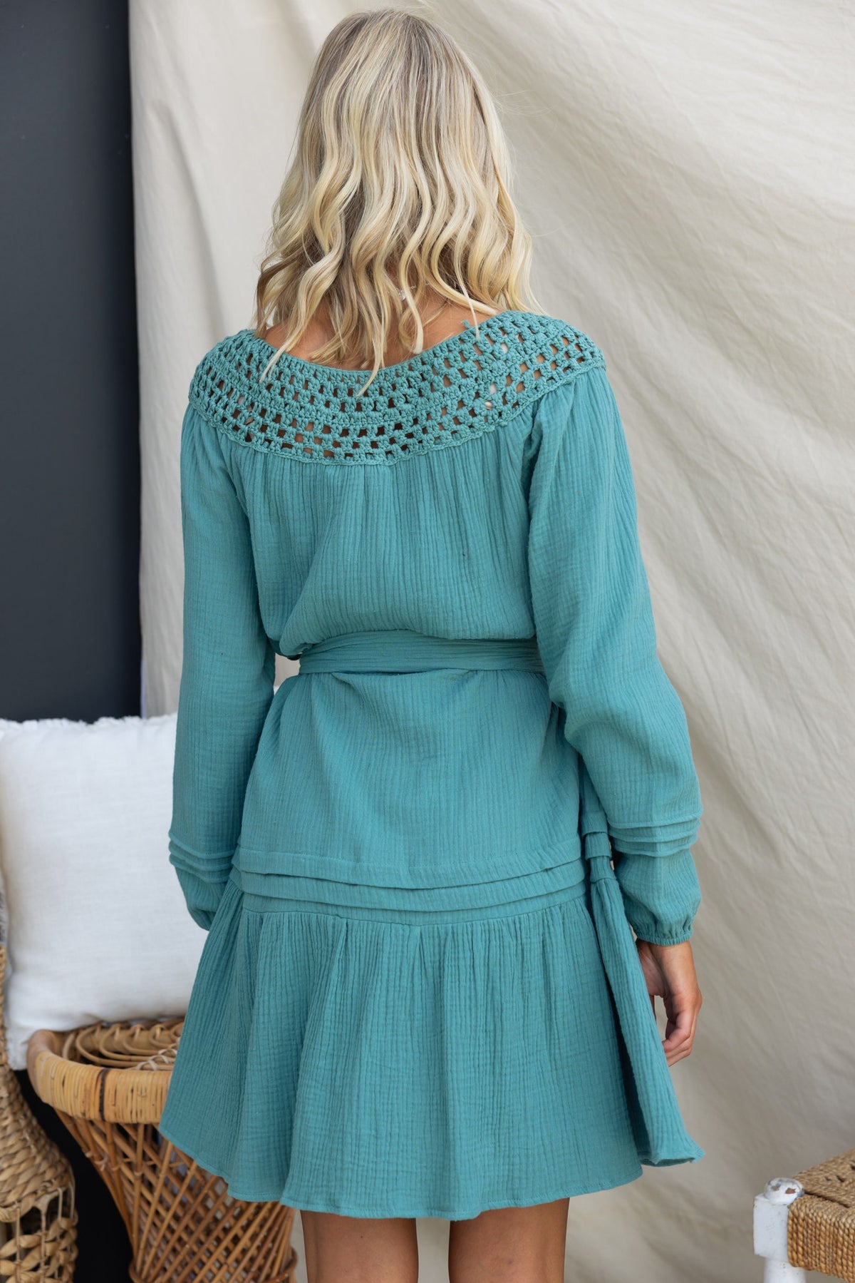 Back view of Hejda Dress featuring crochet detail at neckline, long sleeves, and removable tie in a relaxed fit.