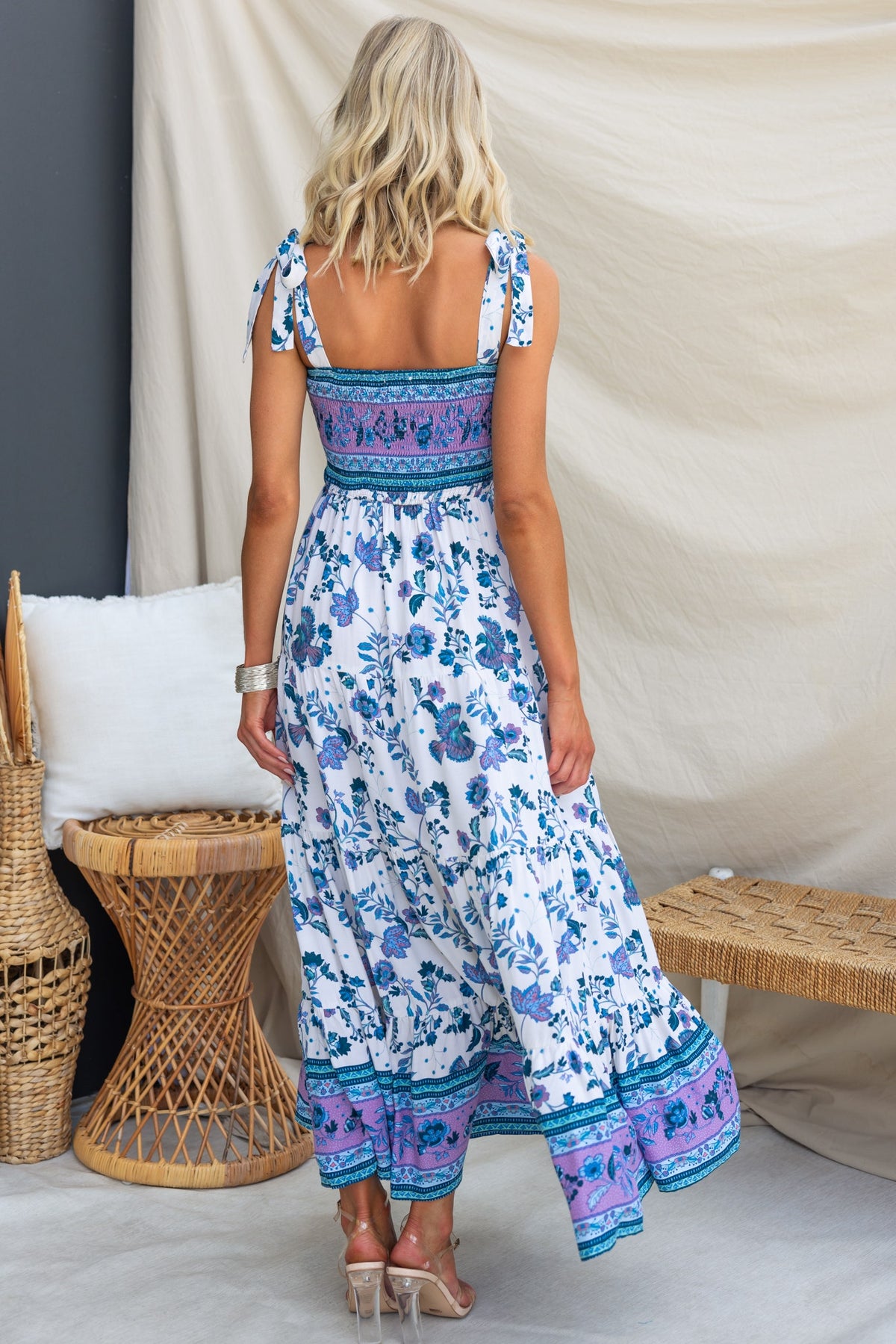 Back view of Adios Maxi Dress featuring adjustable tie straps and floral print design.