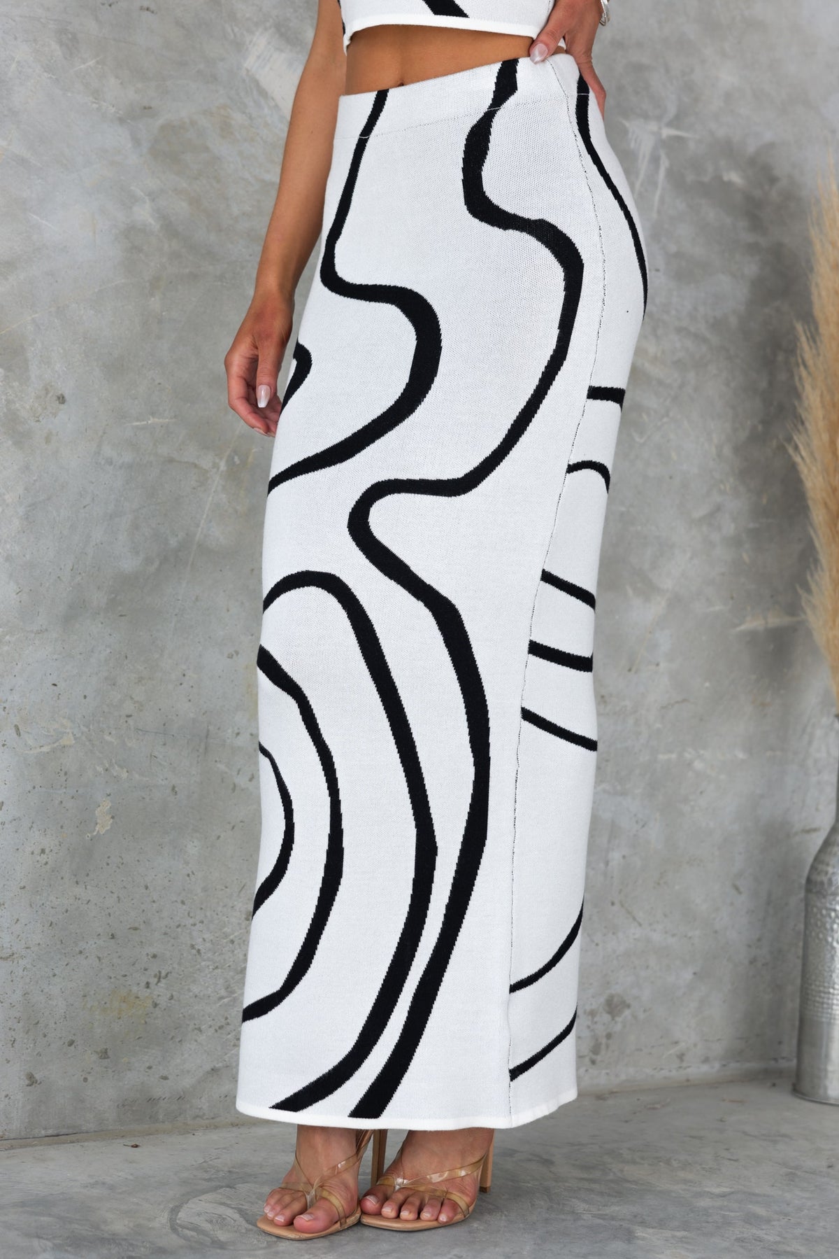 Undisturbed Maxi Skirt featuring a mid-high waist fit with a stylish black and white abstract design, made of stretchy knit material.