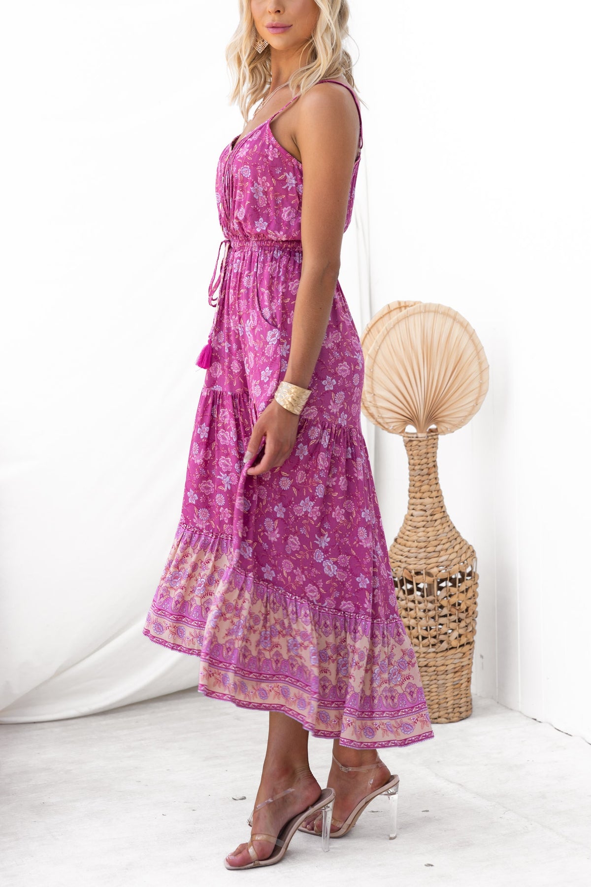 Model wearing Sadelle Midi Dress featuring floral print, adjustable straps, and elastic waistband with pockets.