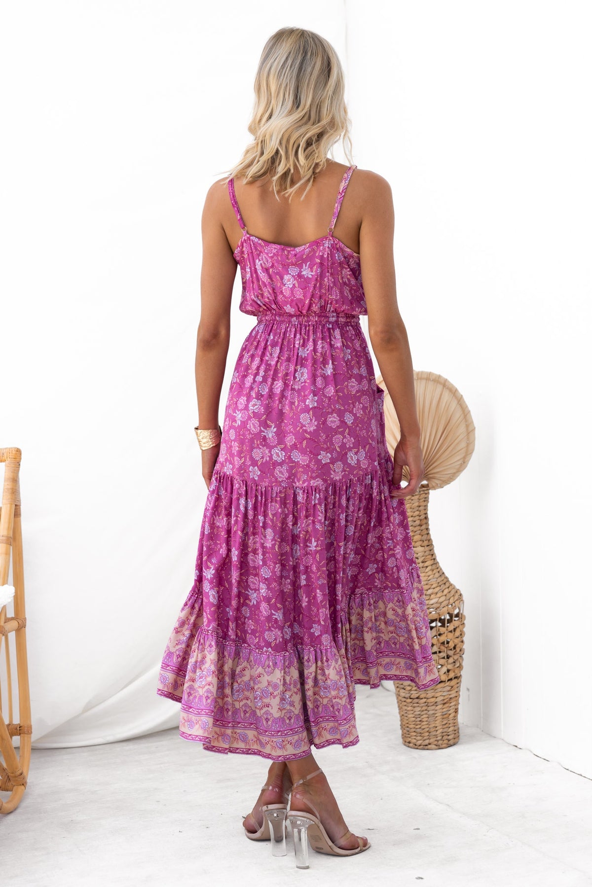 Back view of the Sadelle Midi Dress with floral pattern and adjustable straps, showcasing a relaxed fit and tiered skirt.