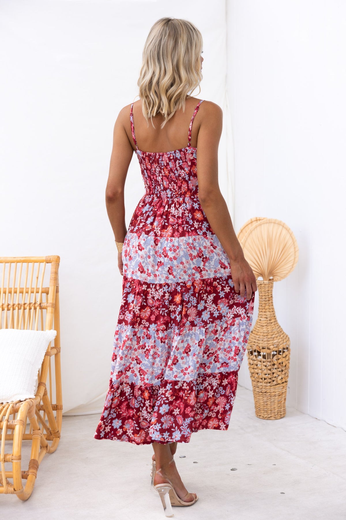 Back view of a woman wearing the Aryana Midi Dress with adjustable straps and floral pattern.