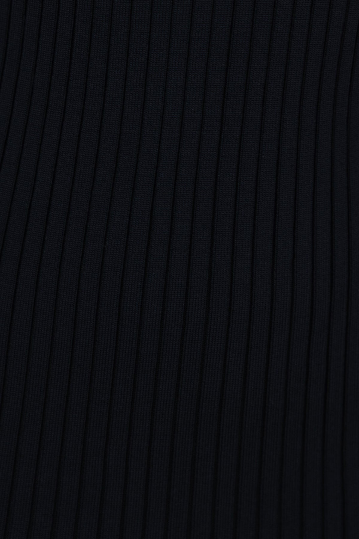 Close-up of ribbed black fabric showcasing the texture and stretch of the material for the Ramzy Dress.