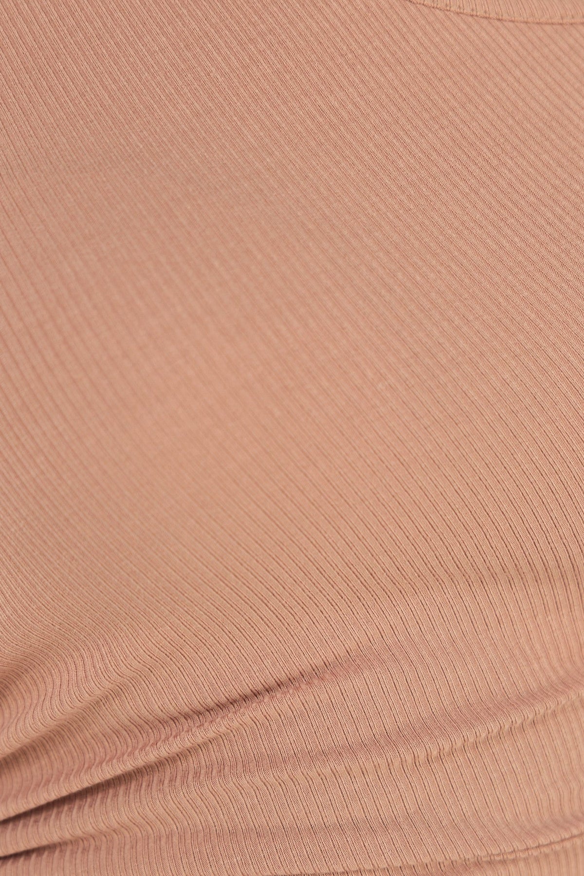 Close-up of ribbed fabric in soft beige hue, showcasing stretch and texture for comfortable wear.