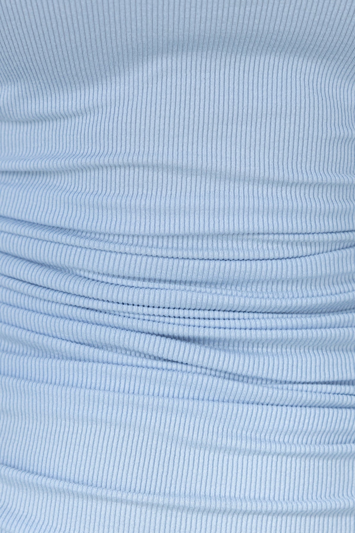 Close-up of light blue ribbed fabric showcasing adjustable ruching details.