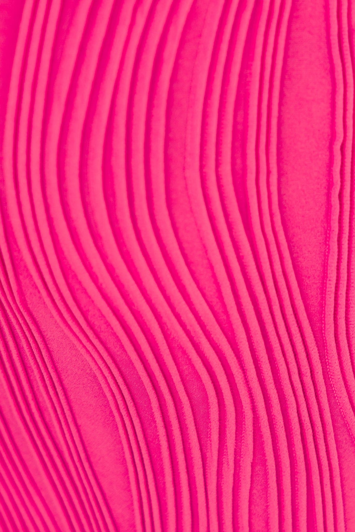 Close-up of textured pink fabric showcasing wavy lines, ideal for the Pamalo Maxi Dress.