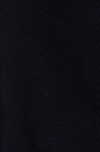 Black knit fabric texture of Aera Top, featuring a stylish design with stretch and relaxed fit.